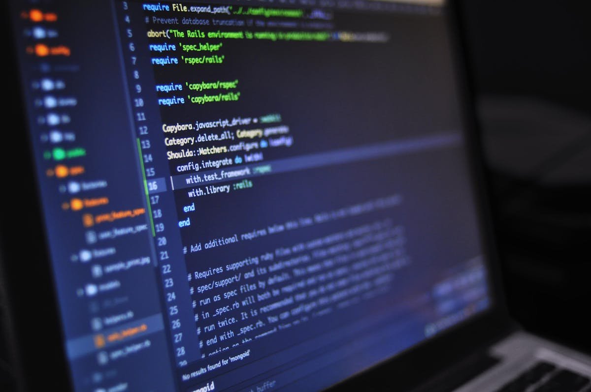 Developer writing CI/CD pipeline configuration on a laptop